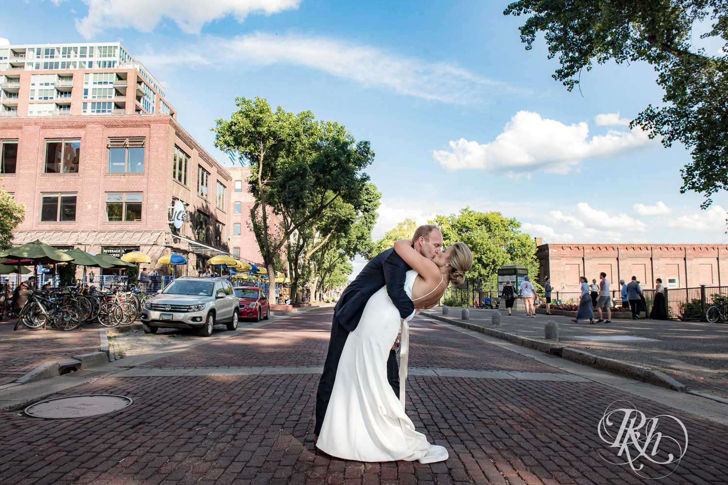 Bride and groom kiss under in the street on their wedding day in Minneapolis, Minnesota.