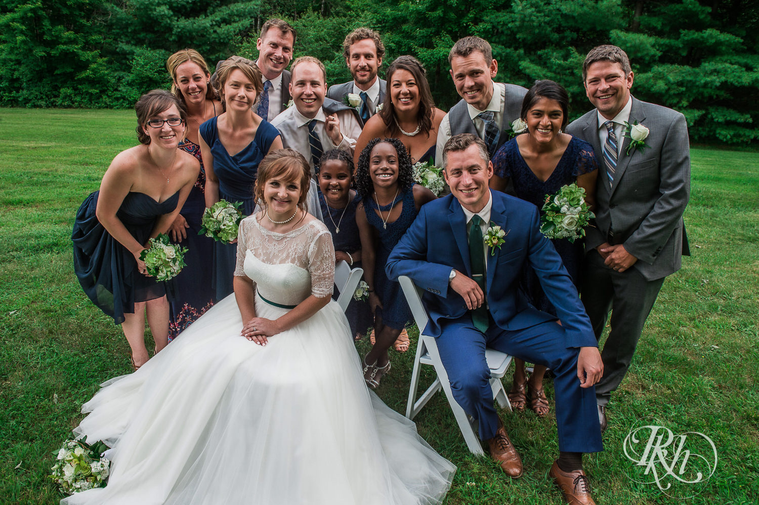 Wedding party and bride and groom smile in Elk Mound, Wisconsin.