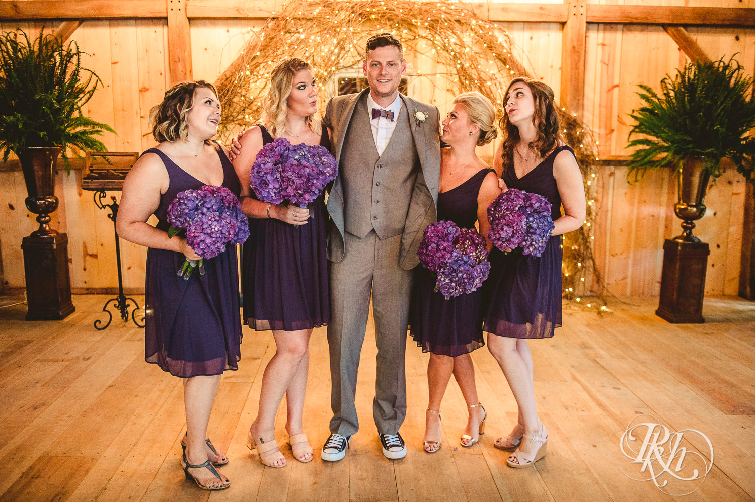 Wedding party smiles in the barn at Camrose Hill Flower Farm in Stillwater, Minnesota.