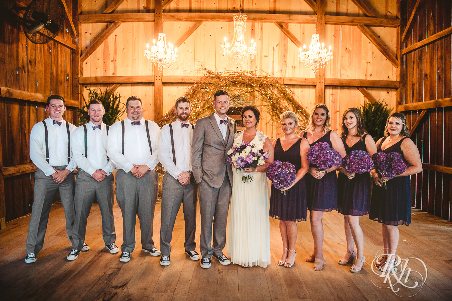 Wedding party smiles in the barn at Camrose Hill Flower Farm in Stillwater, Minnesota.