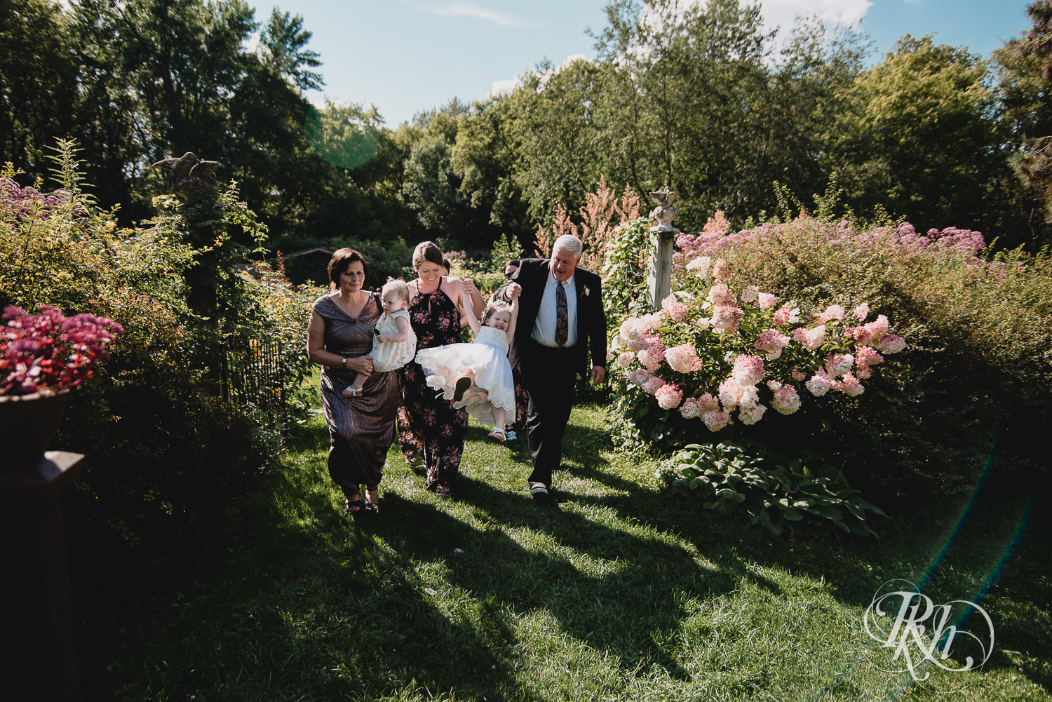 Parents walk down the aisle after wedding ceremony at Camrose Hill Flower Farm in Stillwater, Minnesota.