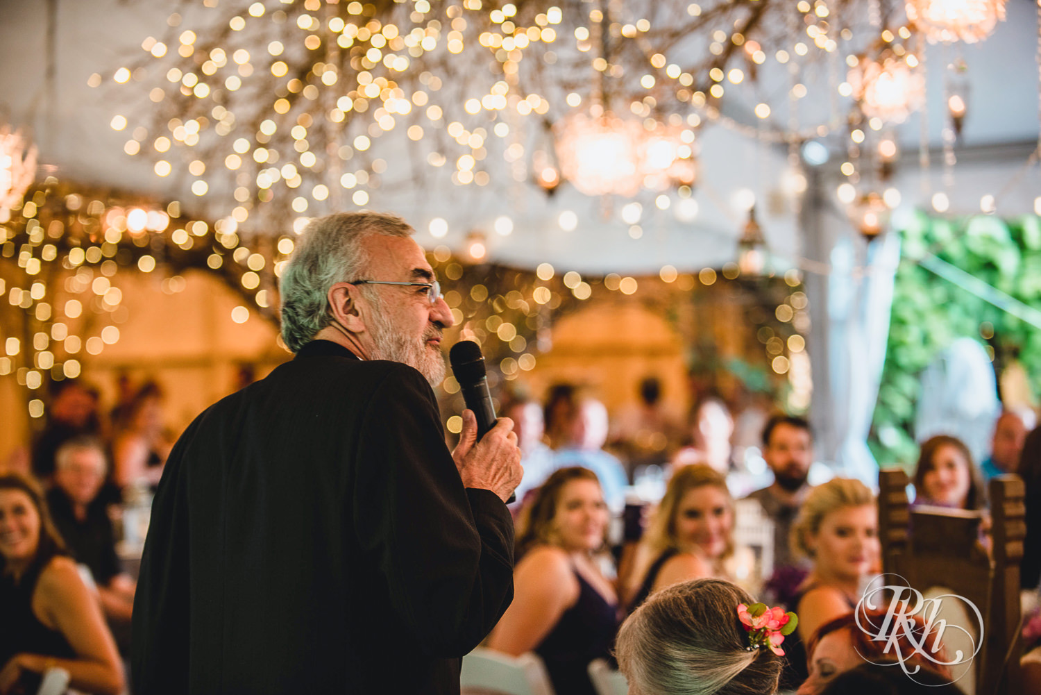 Guests read speeches during reception at Camrose Hill Flower Farm in Stillwater, Minnesota.