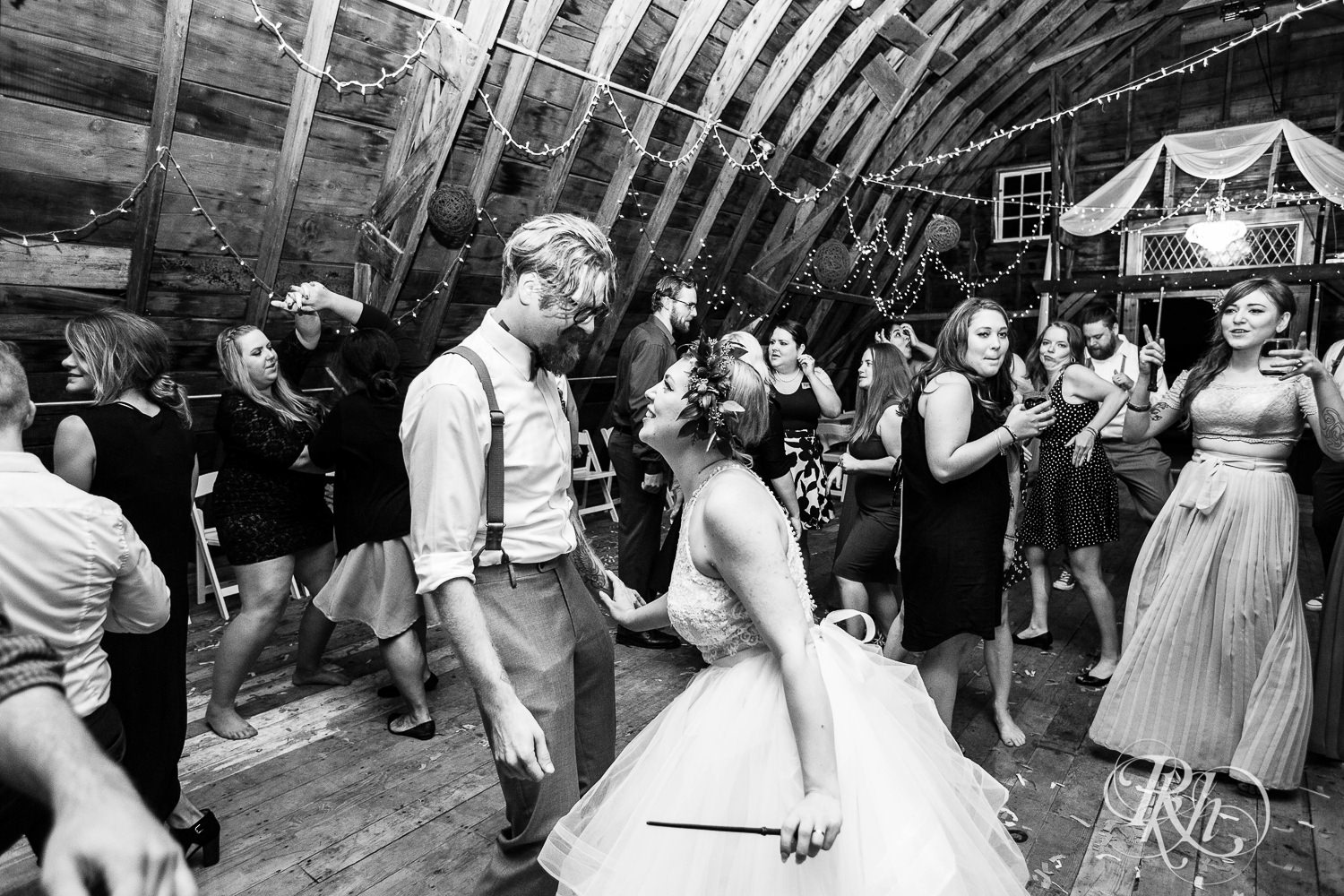Guests dance during wedding reception at Coops Event Barn in Dodge Center, Minnesota.