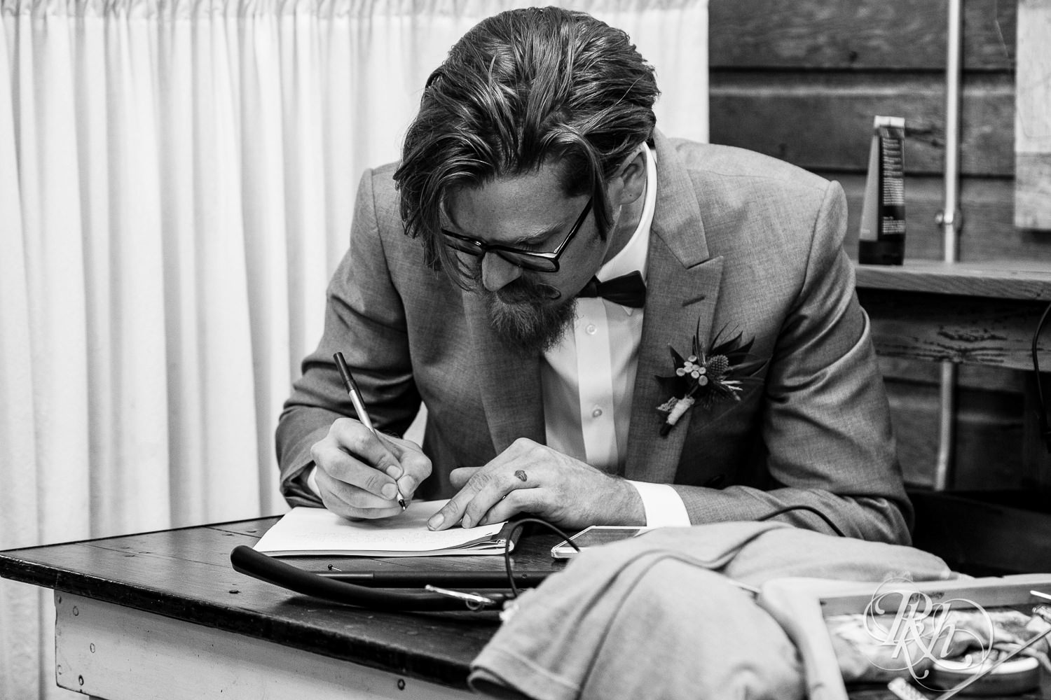 Groom writes vows before wedding at Coops Event Barn in Dodge Center, Minnesota.