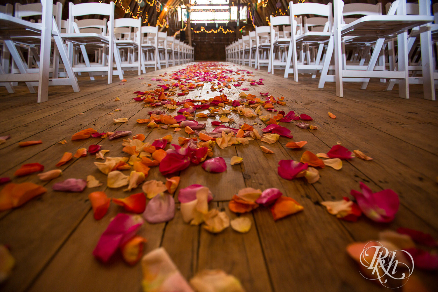 Indoor barn wedding ceremony space at Coops Event Barn in Dodge Center, Minnesota.