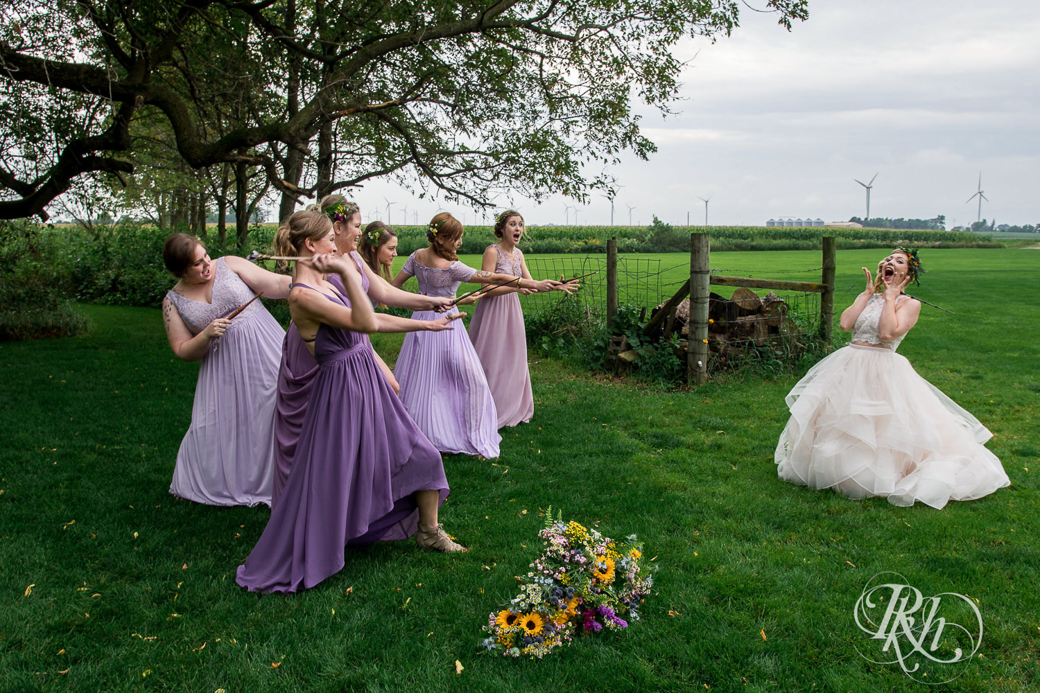 Bride smiles with wedding party holding wands before wedding at Coops Event Barn in Dodge Center, Minnesota.