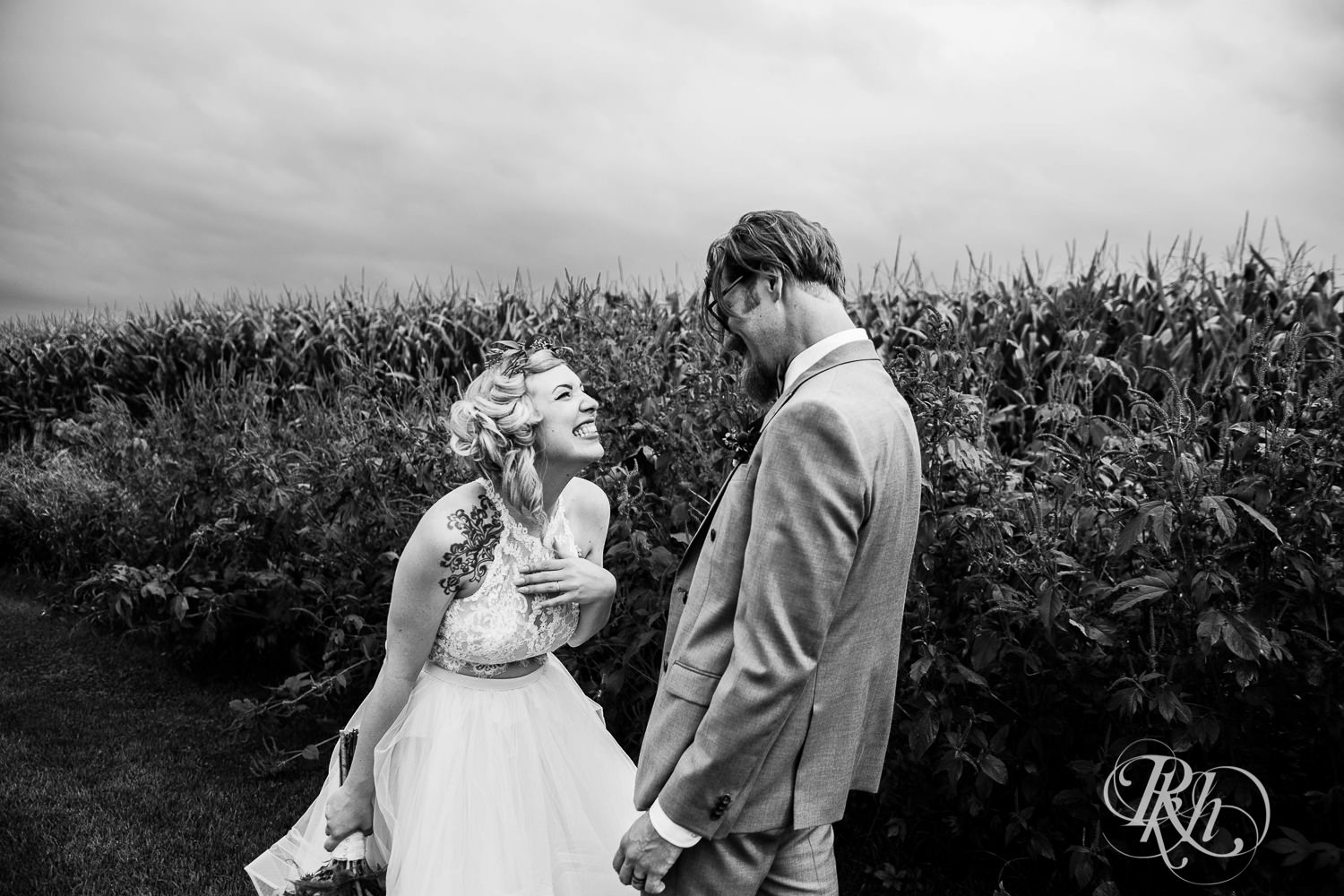Bride and groom laugh at Coops Event Barn in Dodge Center, Minnesota.