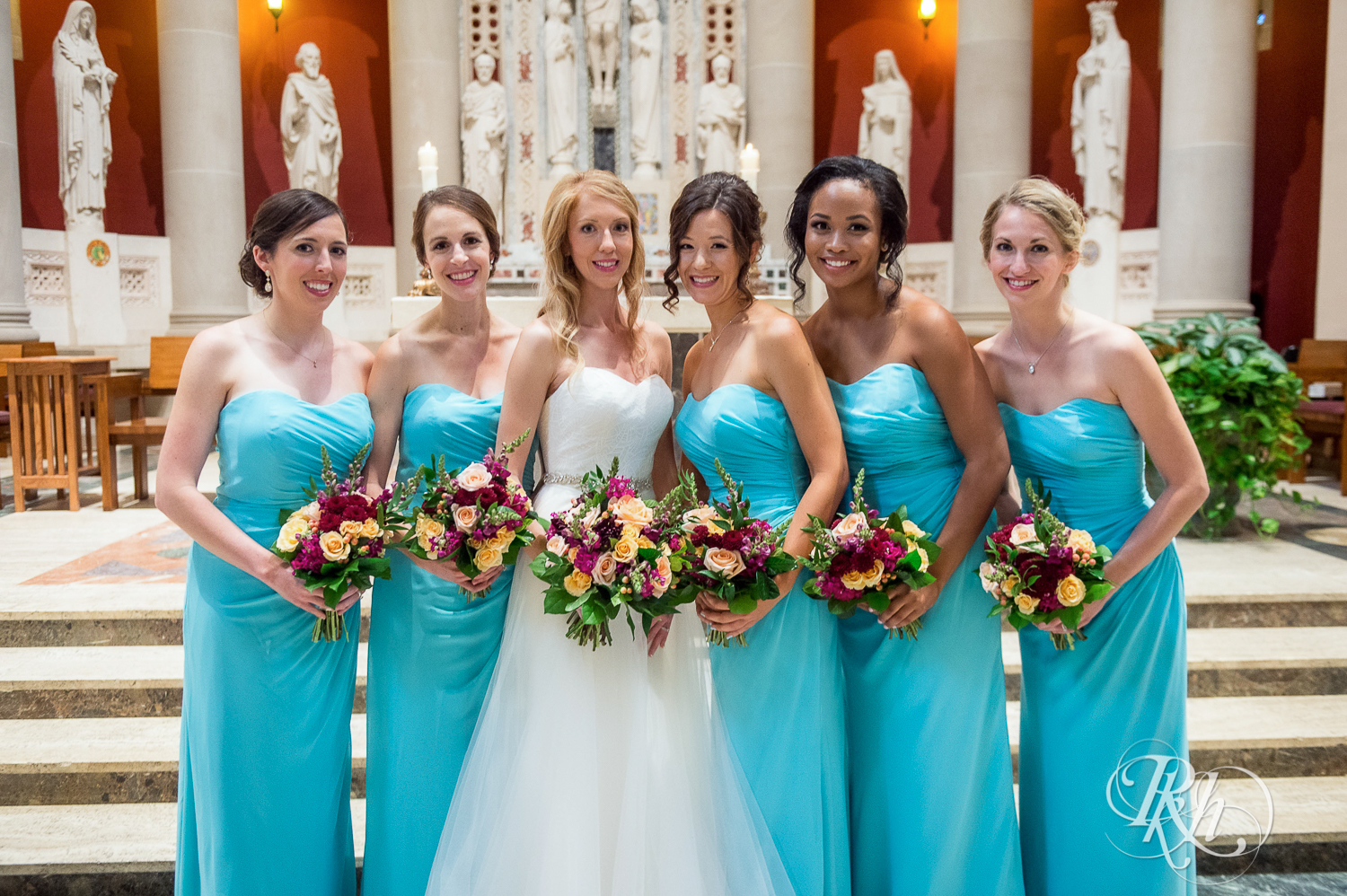Wedding party smiles on the alter of St. Thomas Moore Catholic Church in Saint Paul, Minnesota.