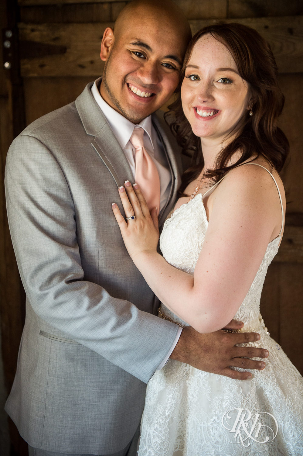 Asian groom and bride smile on wedding day at Birch Hill Barn in Glenwood City, Wisconsin.