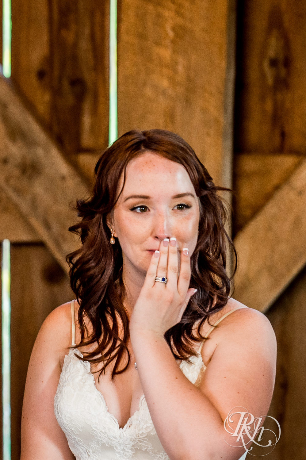 Bride cries during wedding reception speeches at Birch Hill Barn in Glenwood City, Wisconsin.