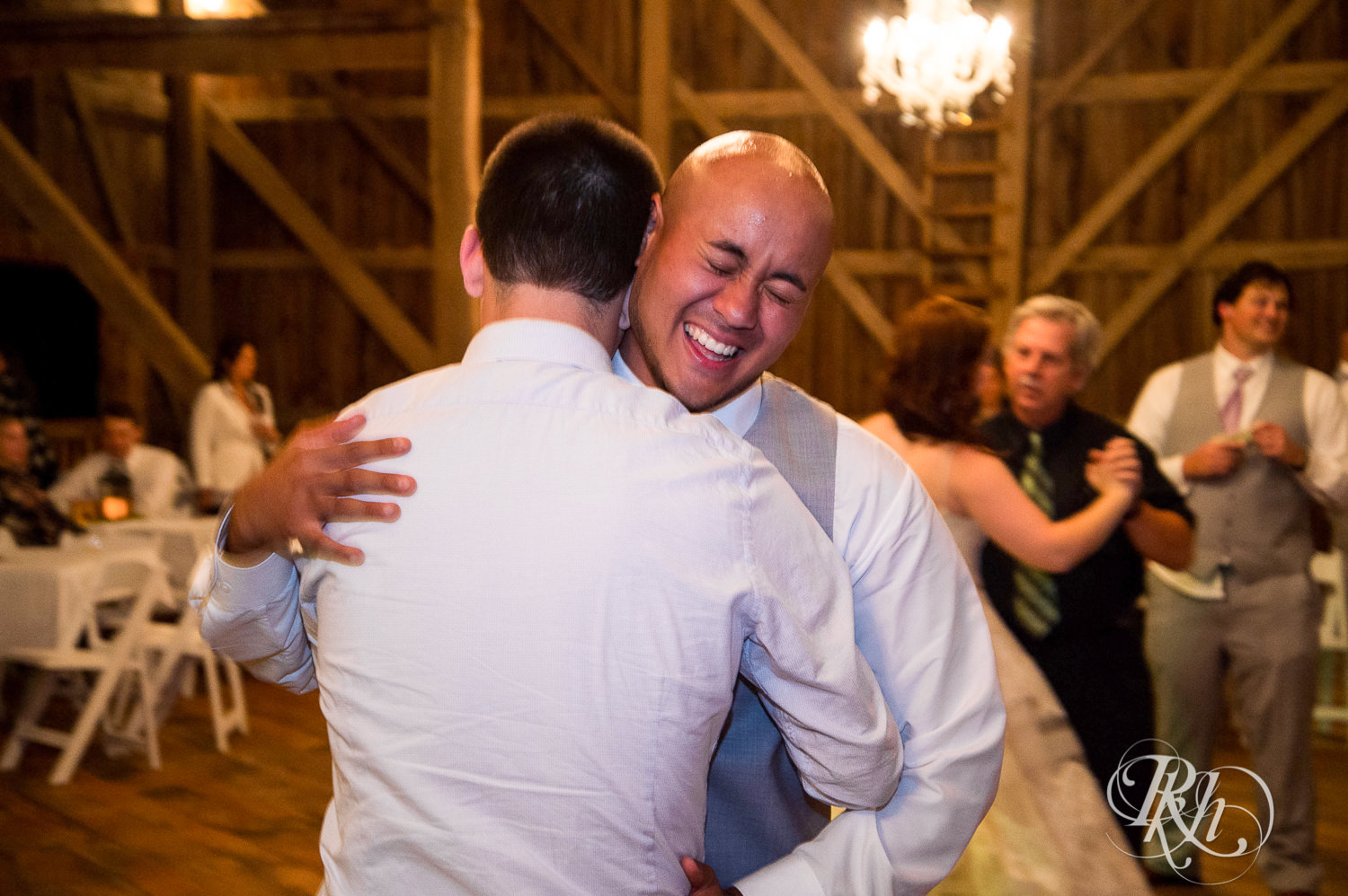 Bride and guests dance during wedding reception at Birch Hill Barn in Glenwood City, Wisconsin.