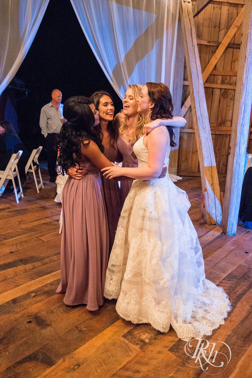 Bride and guests dance during wedding reception at Birch Hill Barn in Glenwood City, Wisconsin.