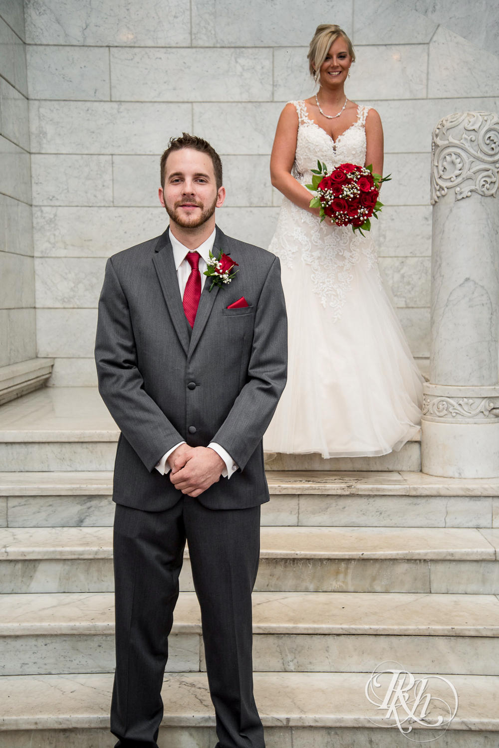 Bride and groom do first look on staircase at Lumber Exchange Event Center in Minneapolis, Minnesota.
