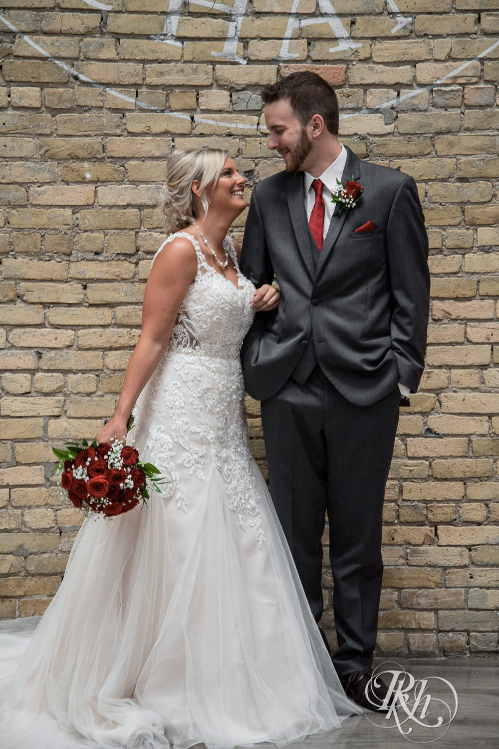 Bride and groom smile on wedding day at Lumber Exchange Event Center in Minneapolis, Minnesota.