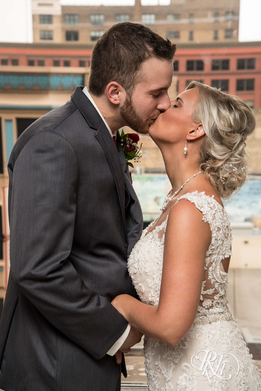 Bride and groom kiss on wedding day at Lumber Exchange Event Center in Minneapolis, Minnesota.