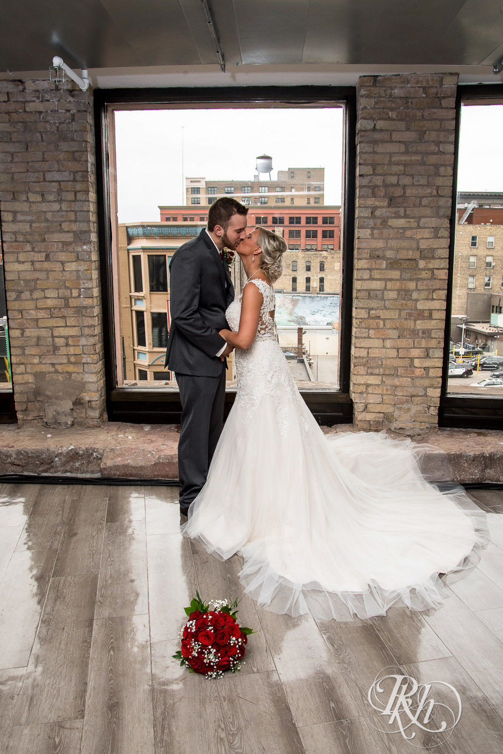 Bride and groom kiss on wedding day at Lumber Exchange Event Center in Minneapolis, Minnesota.