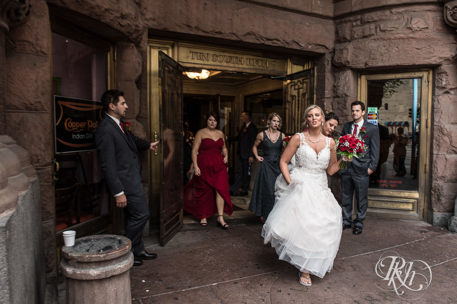 Wedding party smiles on wedding day at Lumber Exchange Event Center in Minneapolis, Minnesota.