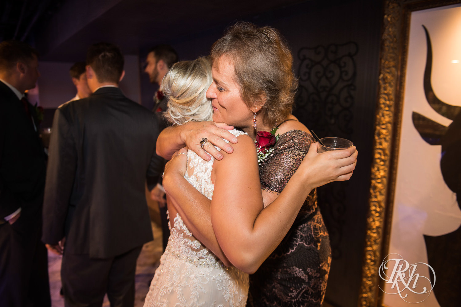 Bride and groom hug guests at the Lumber Exchange Event Center in Minneapolis, Minnesota.
