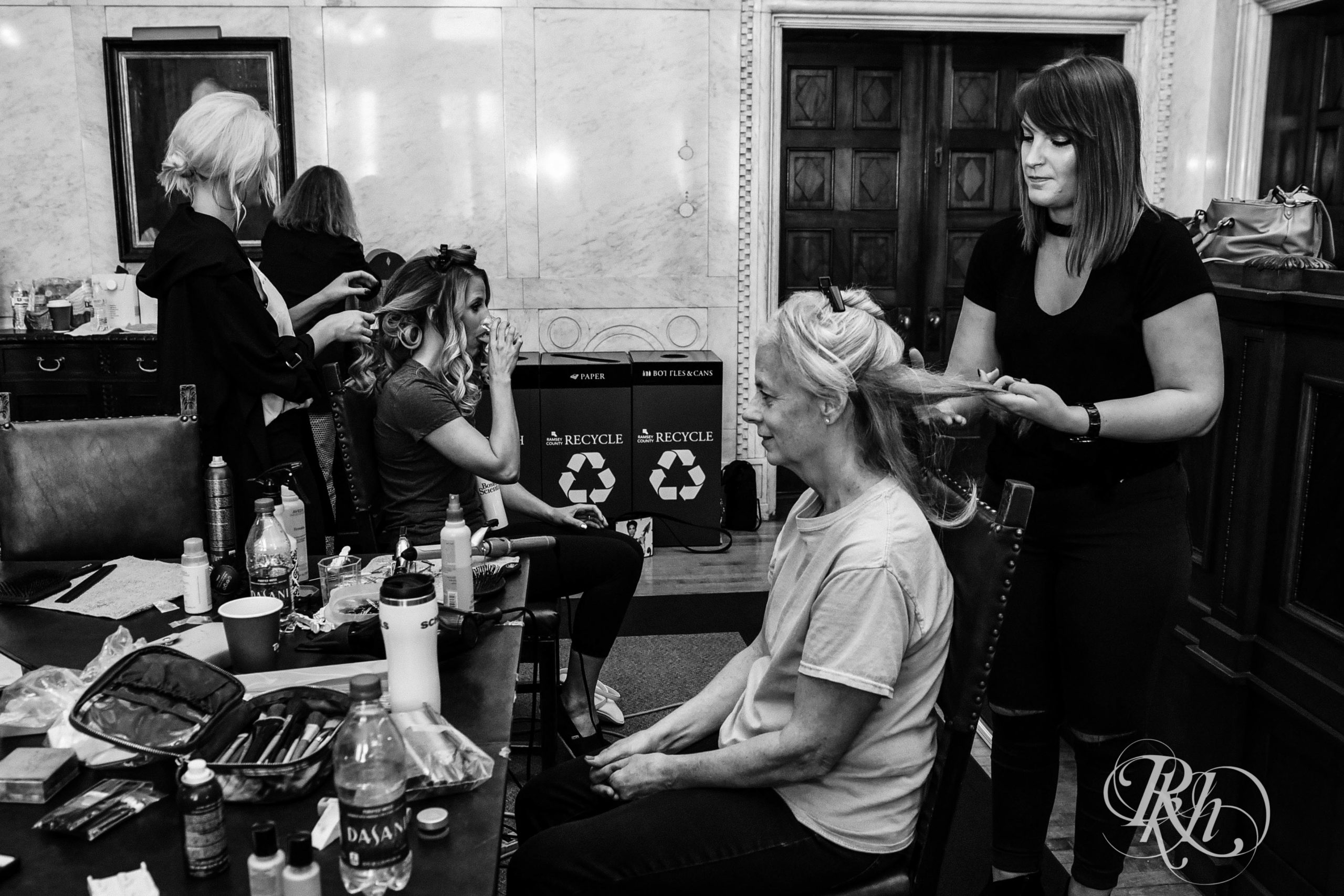 Bride and wedding party getting their hair done before wedding at Landmark Center in Saint Paul, Minnesota.