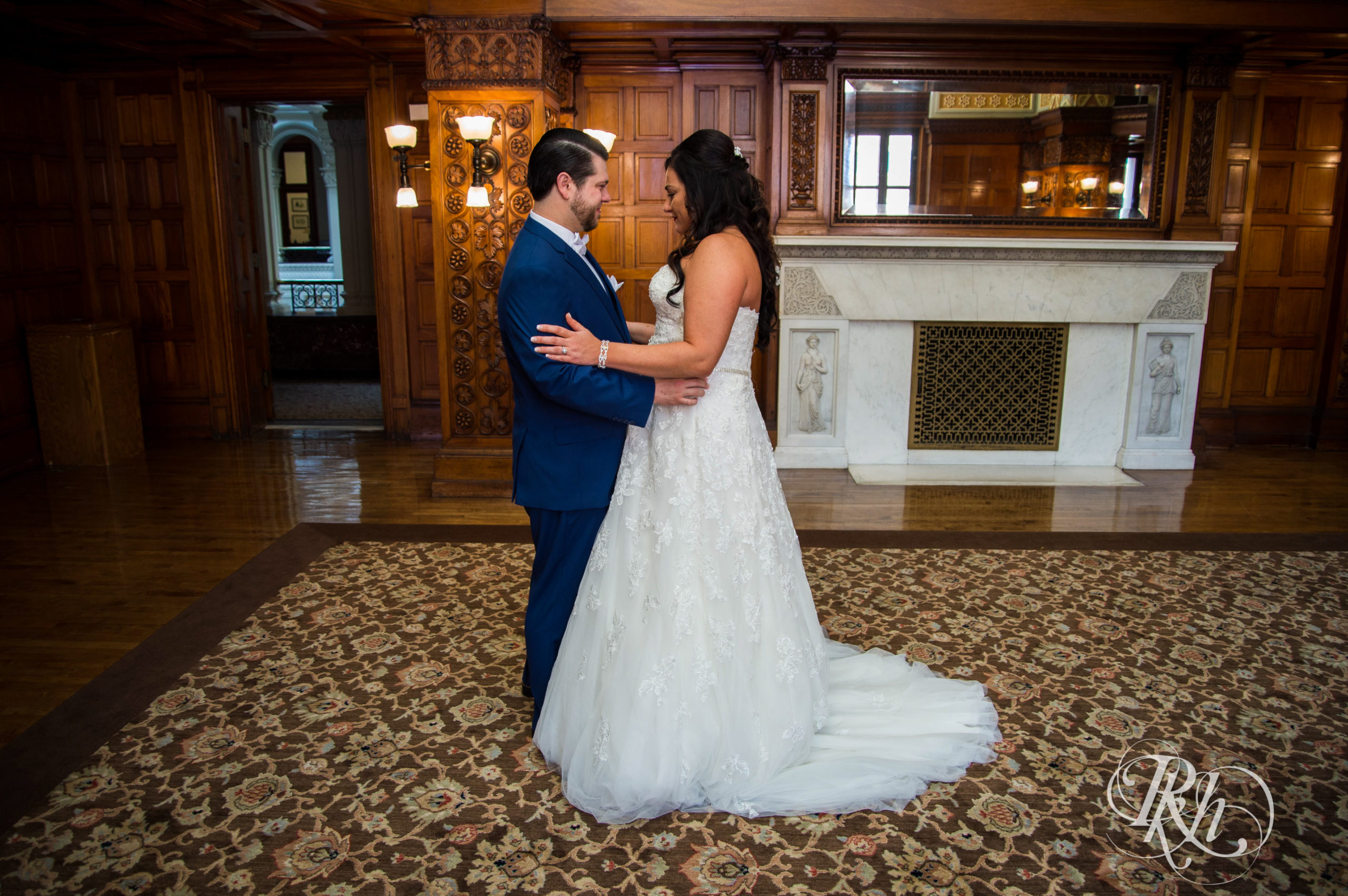 Bride and groom do first look before wedding at Landmark Center in Saint Paul, Minnesota.