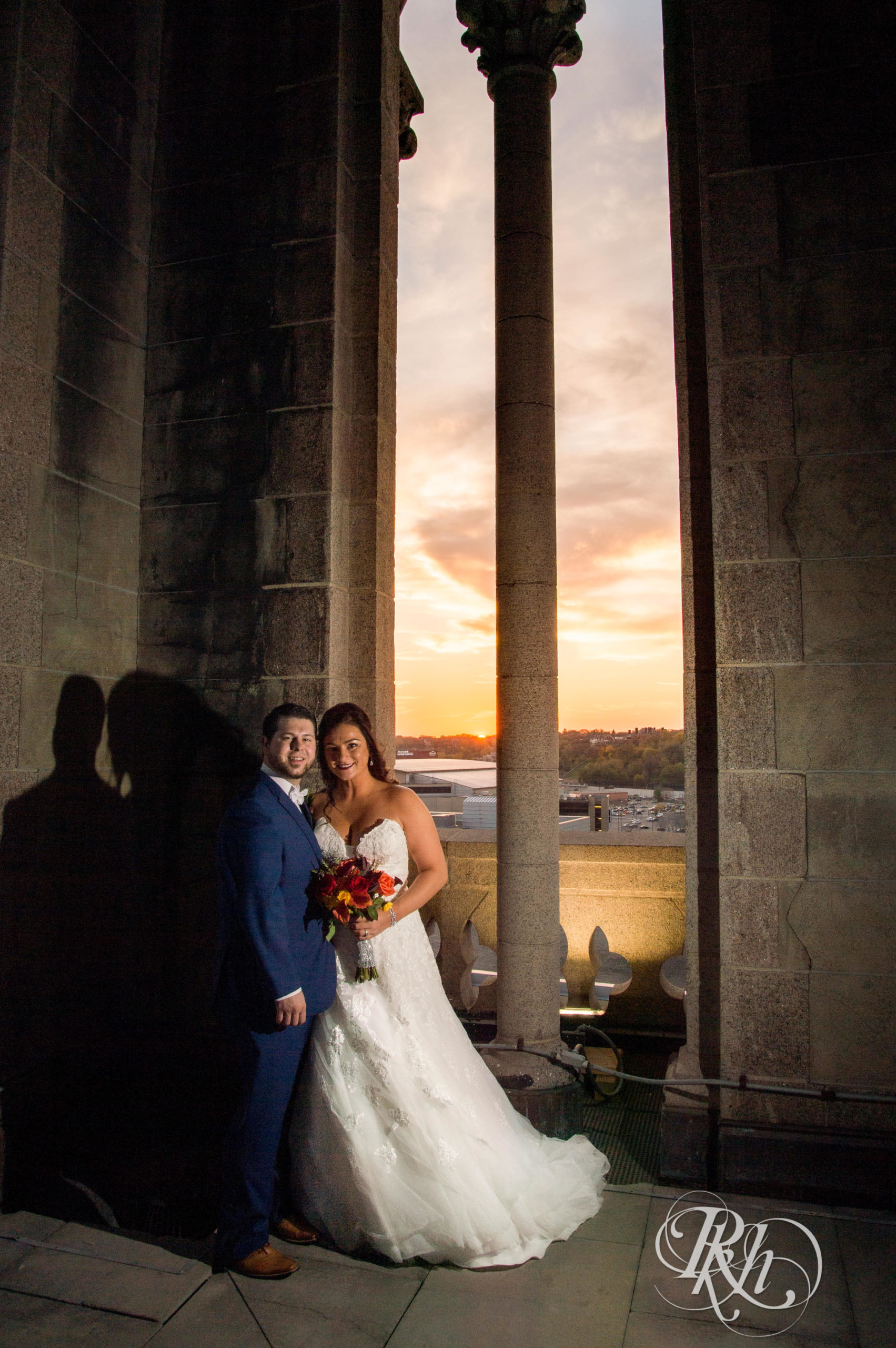 Bride and groom smile at sunset on wedding day at Landmark Center in Saint Paul, Minnesota.