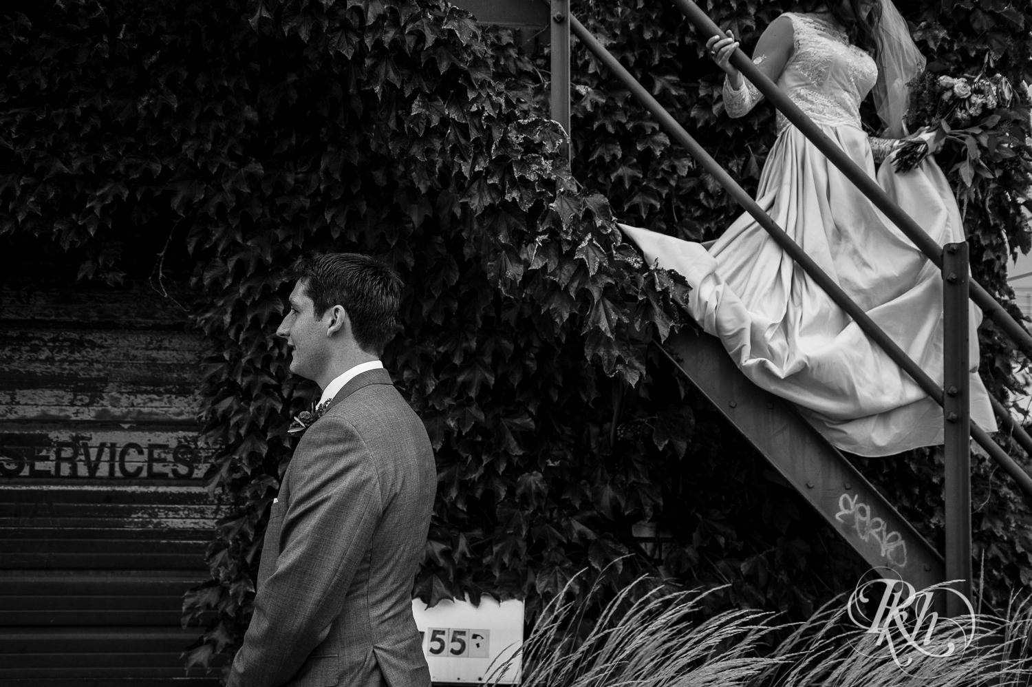 Bride and groom walk on stairs on a rainy wedding day in Minneapolis, Minnesota.