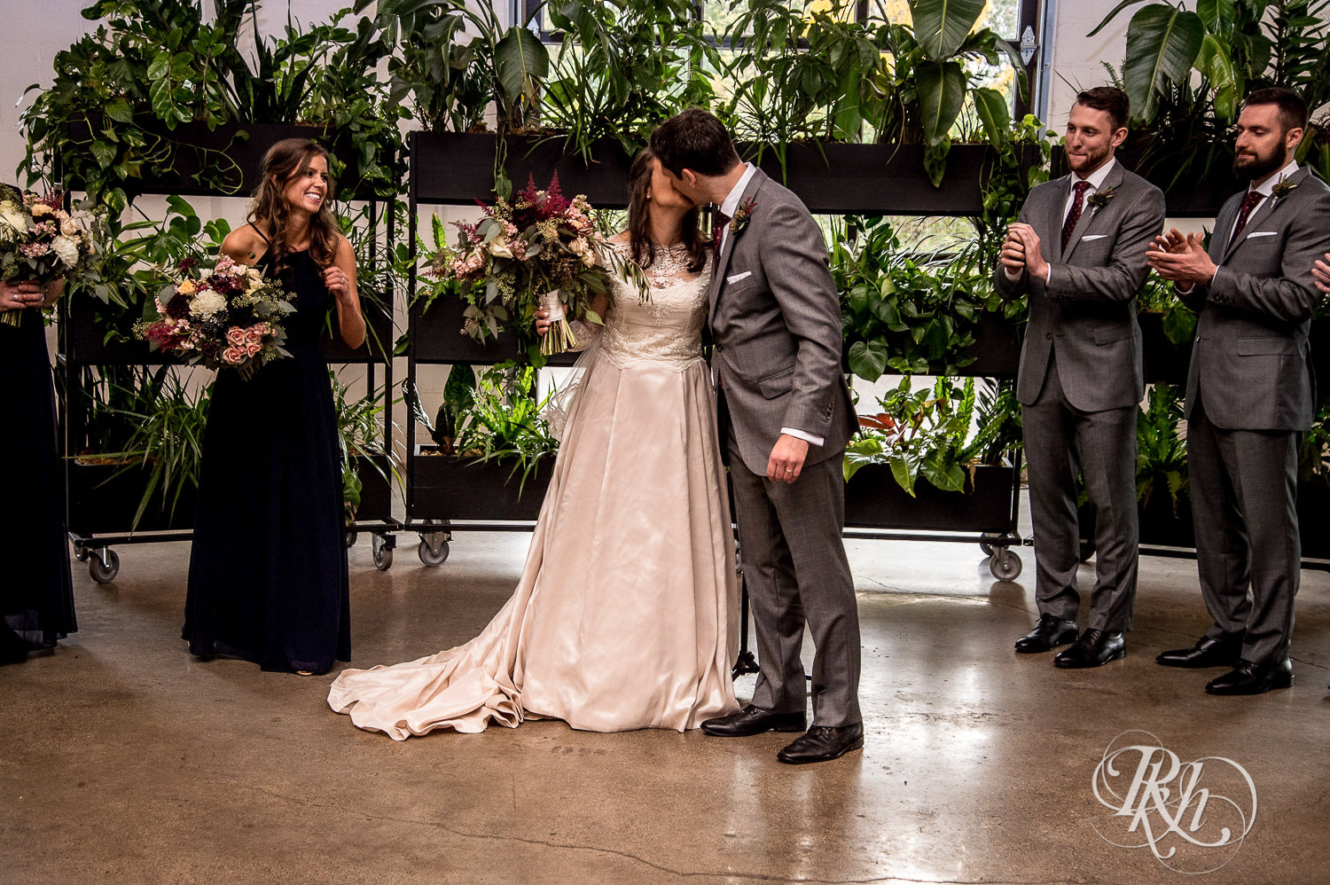 Bride and and groom kiss during wedding ceremony at Paikka in Saint Paul, Minnesota.