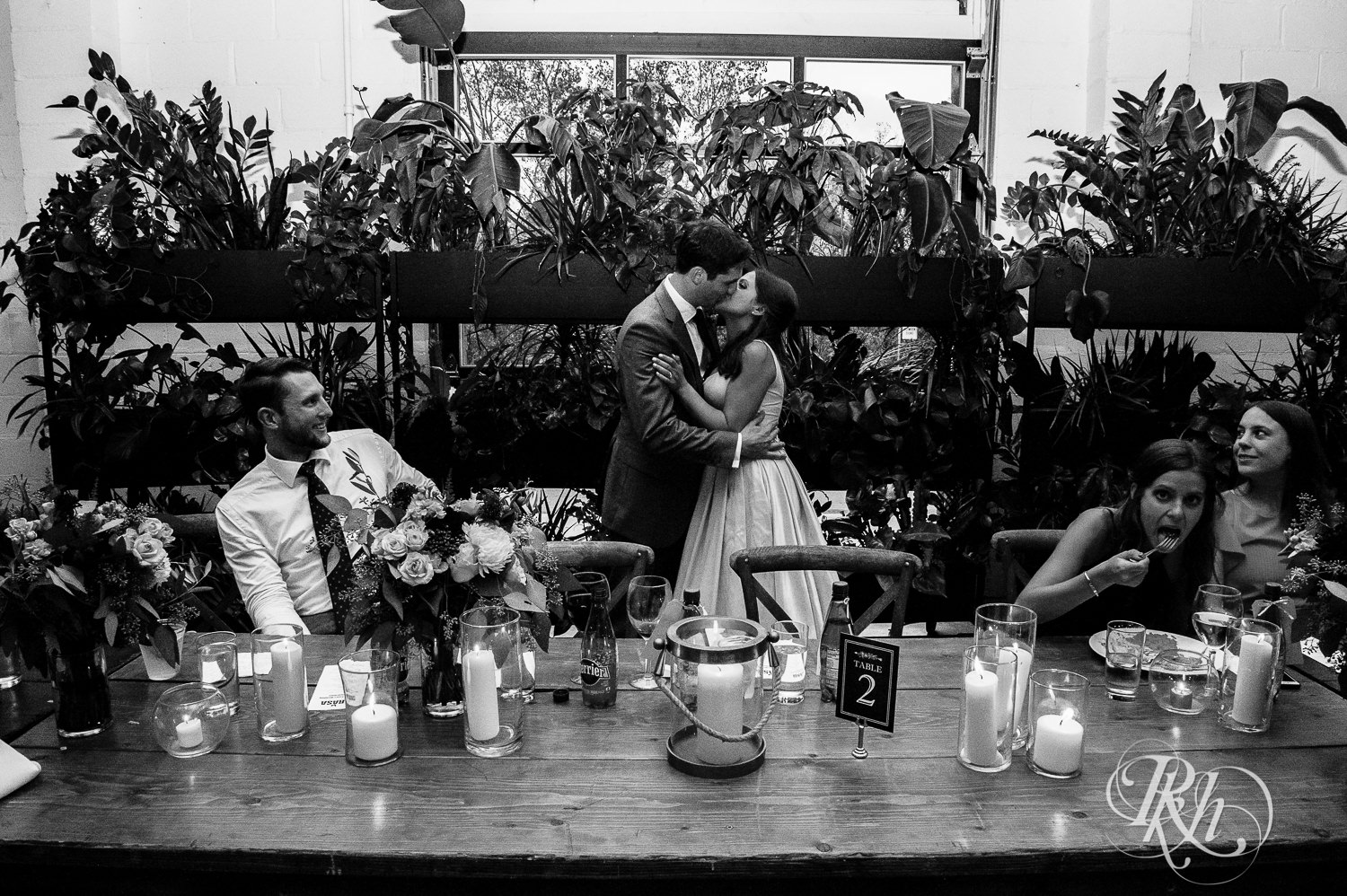 Bride and and groom kiss during wedding reception at Paikka in Saint Paul, Minnesota.
