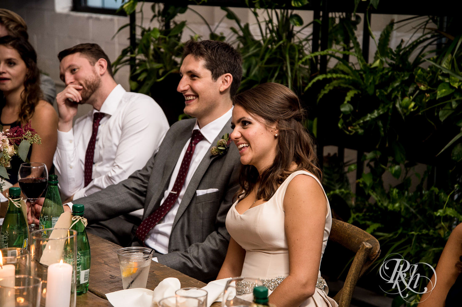 Bride and and groom laugh during wedding reception at Paikka in Saint Paul, Minnesota.