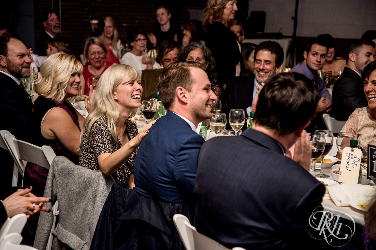 Guests laugh during wedding reception speeches at Paikka in Saint Paul, Minnesota.