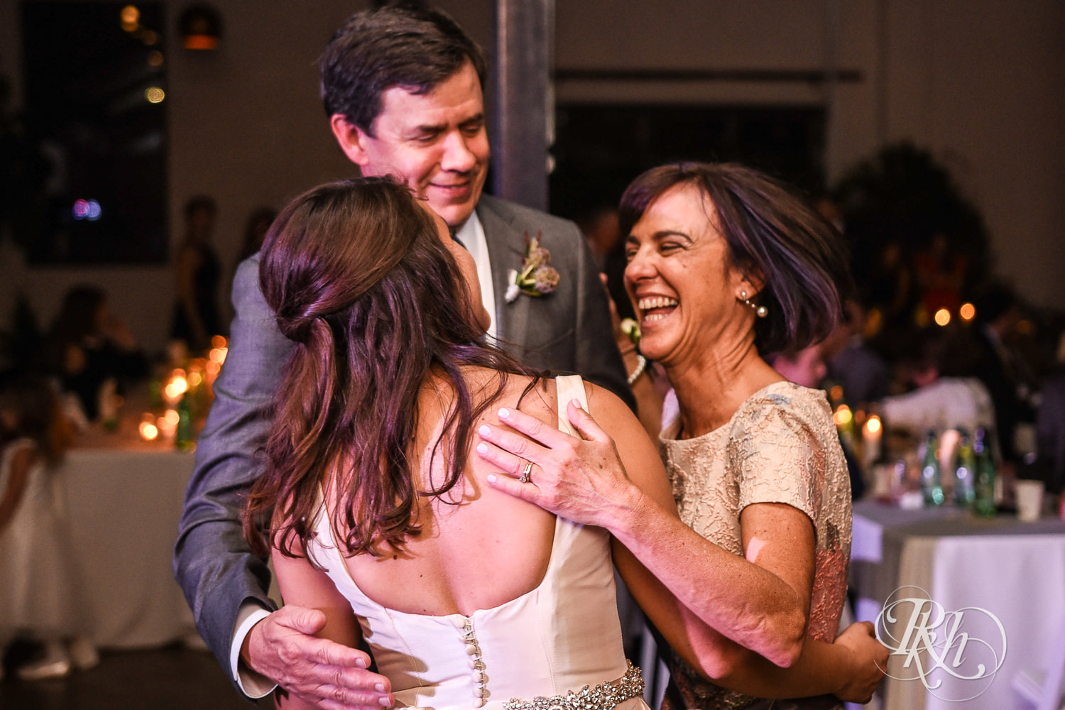 Bride and dances with parents during wedding reception speeches at Paikka in Saint Paul, Minnesota.