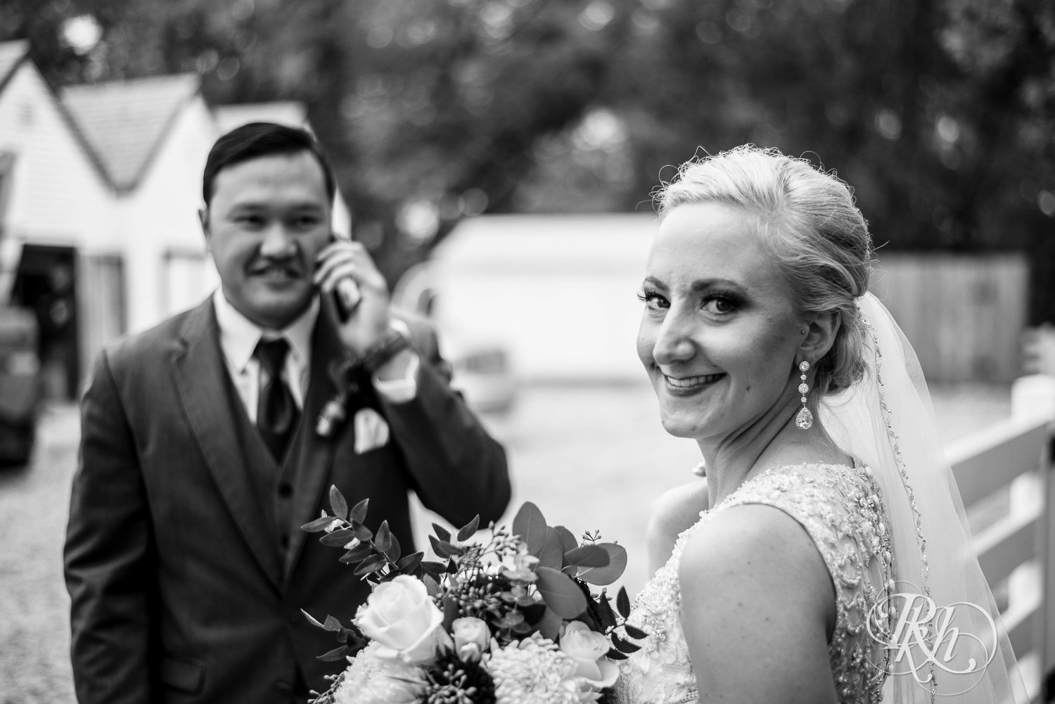 Bride and groom smile on rainy day wedding at Green Acres Event Center in Eden Prairie, Minnesota.