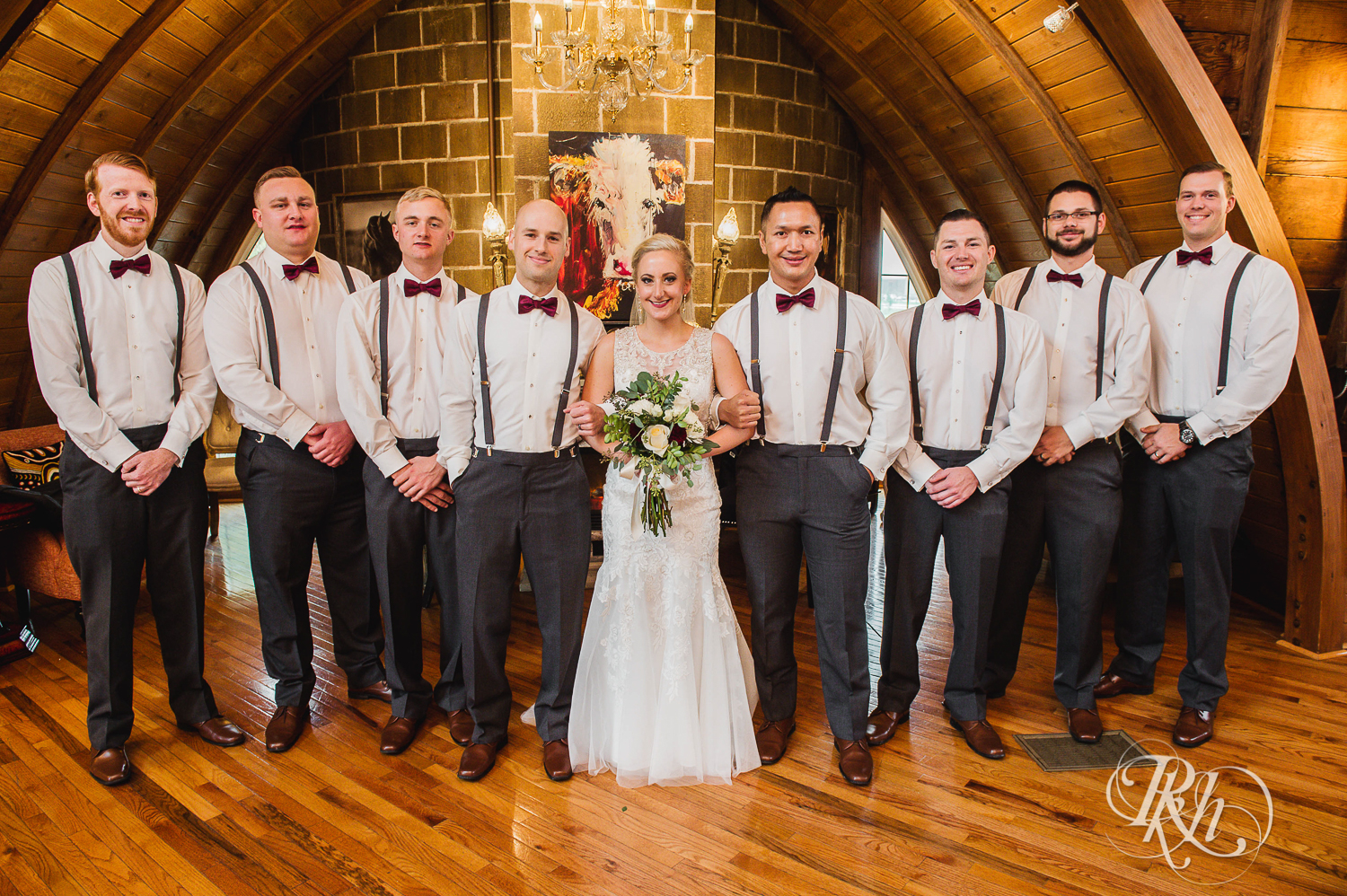 Bride smiles with wedding party at Green Acres Event Center barn wedding in Eden Prairie, Minnesota.