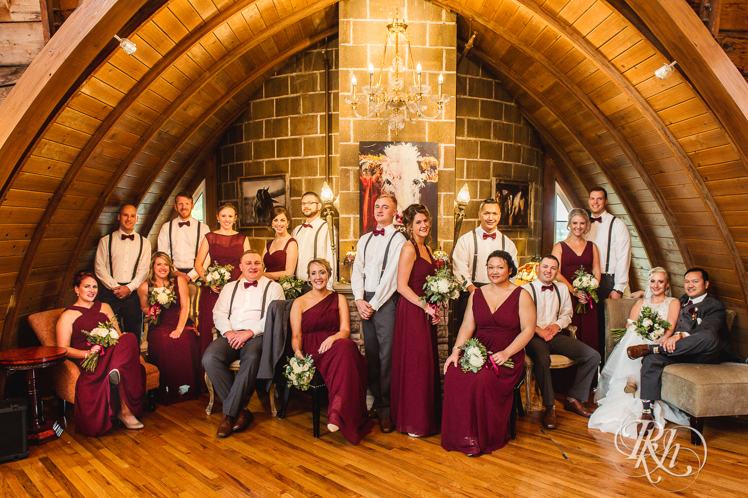 Groom and bride smiles with wedding party at Green Acres Event Center barn wedding in Eden Prairie, Minnesota.