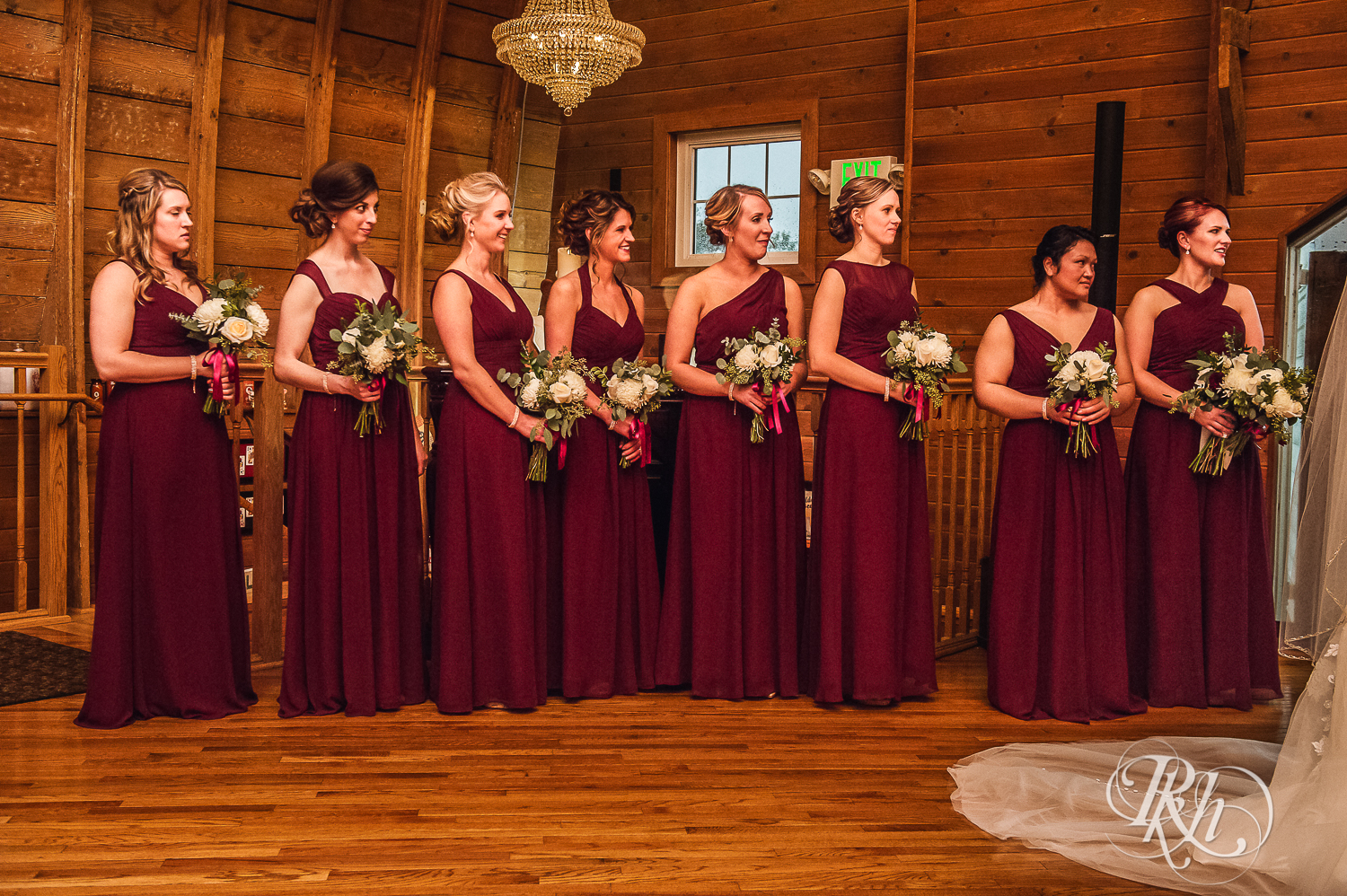 Bridesmaids smile at Green Acres Event Center barn wedding ceremony in Eden Prairie, Minnesota.