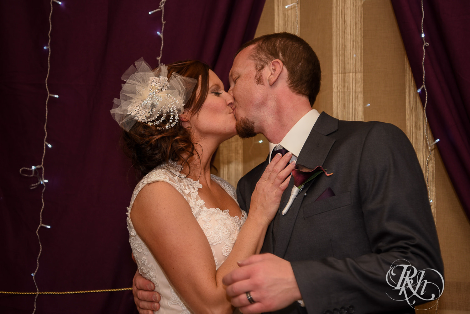 Bride and groom kiss during wedding reception at White Bear Country Inn in White Bear Lake, Minnesota.