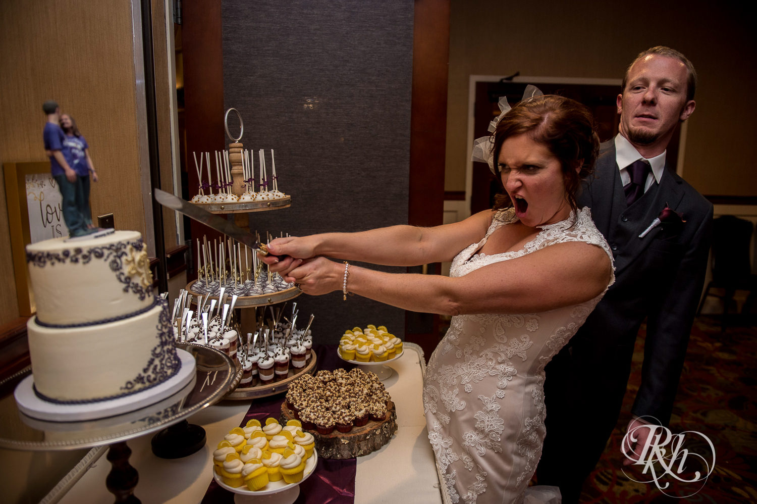 Bride and groom cut cake during wedding reception at White Bear Country Inn in White Bear Lake, Minnesota.