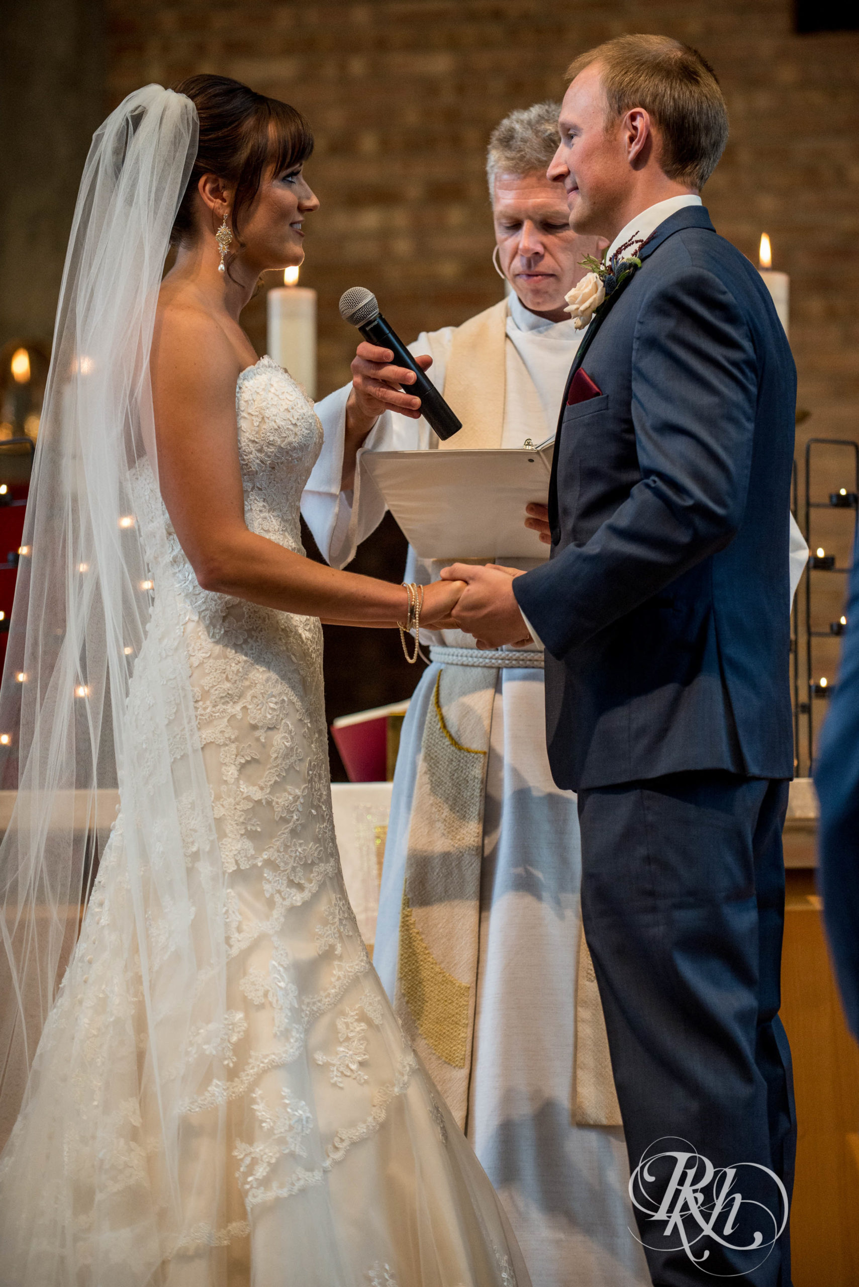 Bride and groom say vows at church wedding ceremony in Minneapolis, Minnesota.