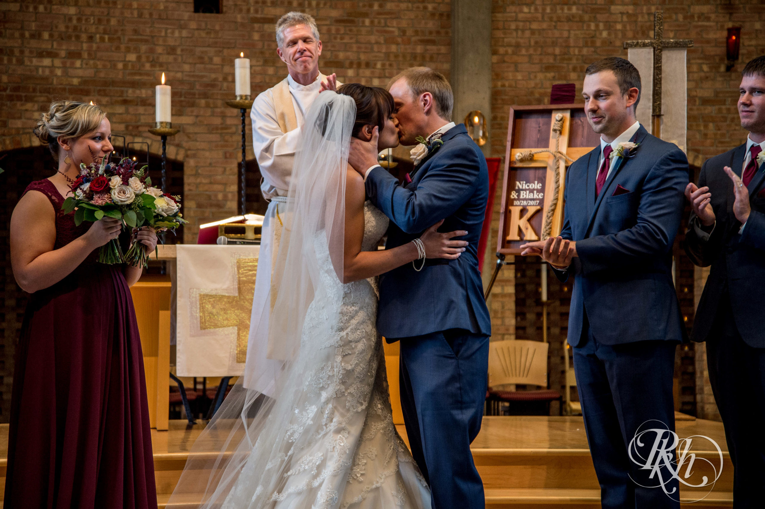 Bride and groom kiss at church wedding ceremony in Minneapolis, Minnesota.