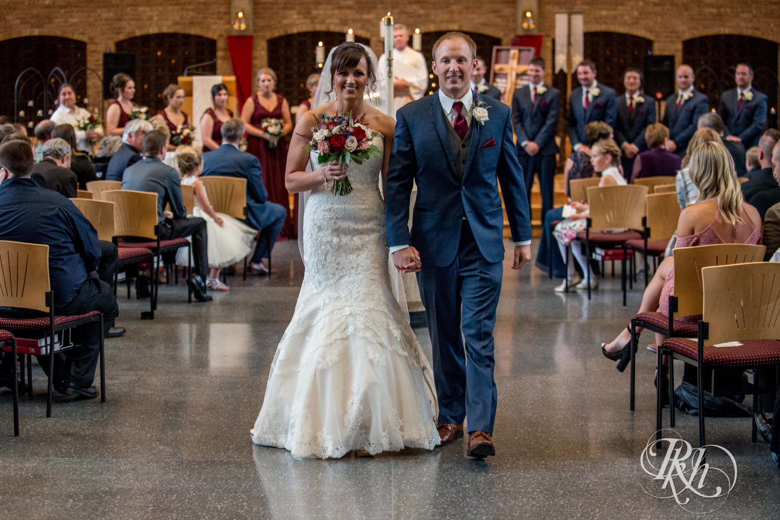 Bride and groom walk down aisle at church wedding ceremony in Minneapolis, Minnesota.