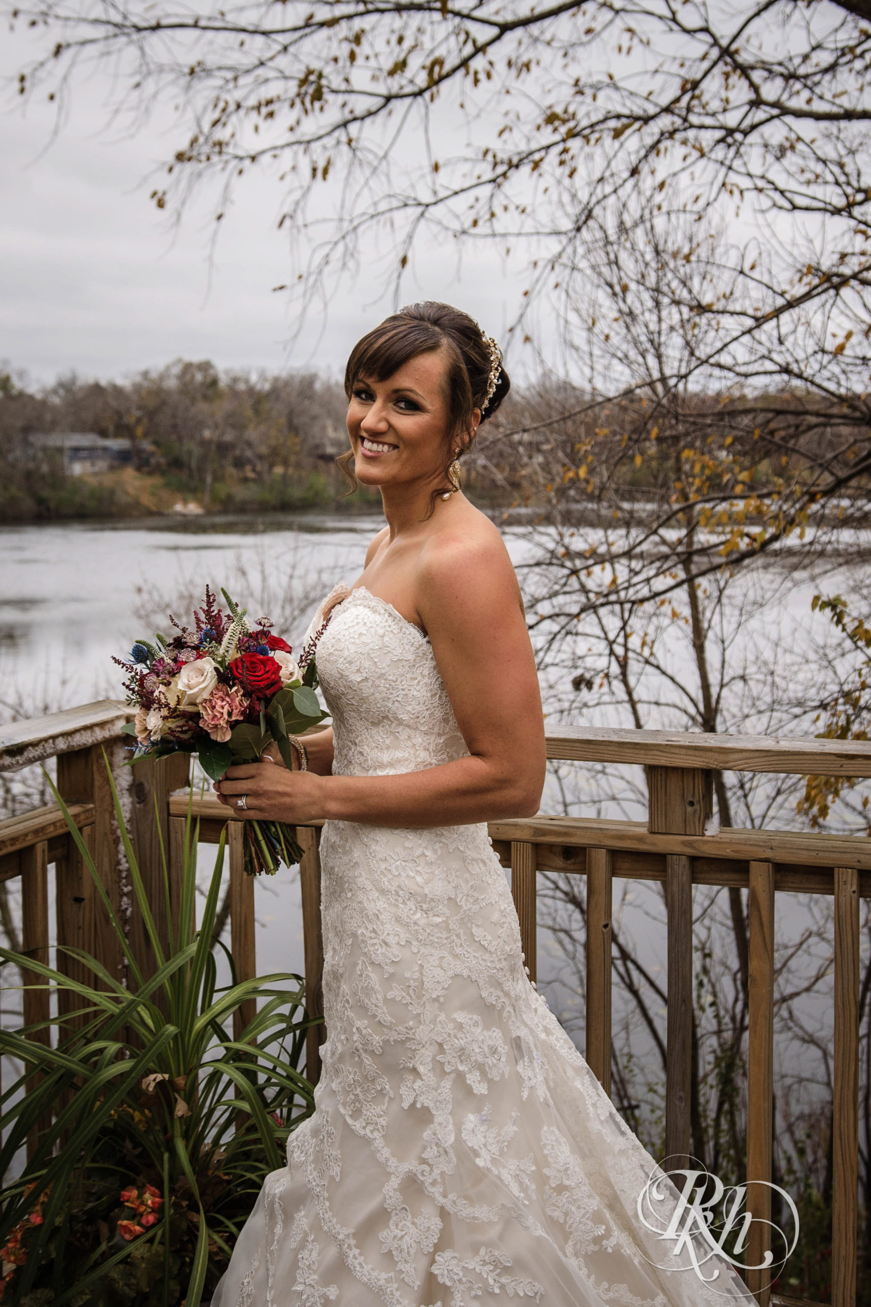 Bride smiles with flowers outside at church wedding in Minneapolis, Minnesota.