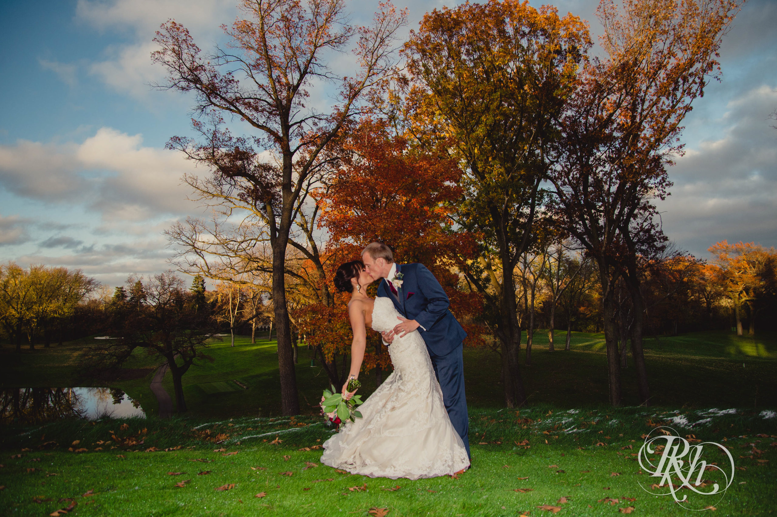 Bride and groom kiss on fall wedding day at Minneapolis Golf Club in Minneapolis, Minnesota.
