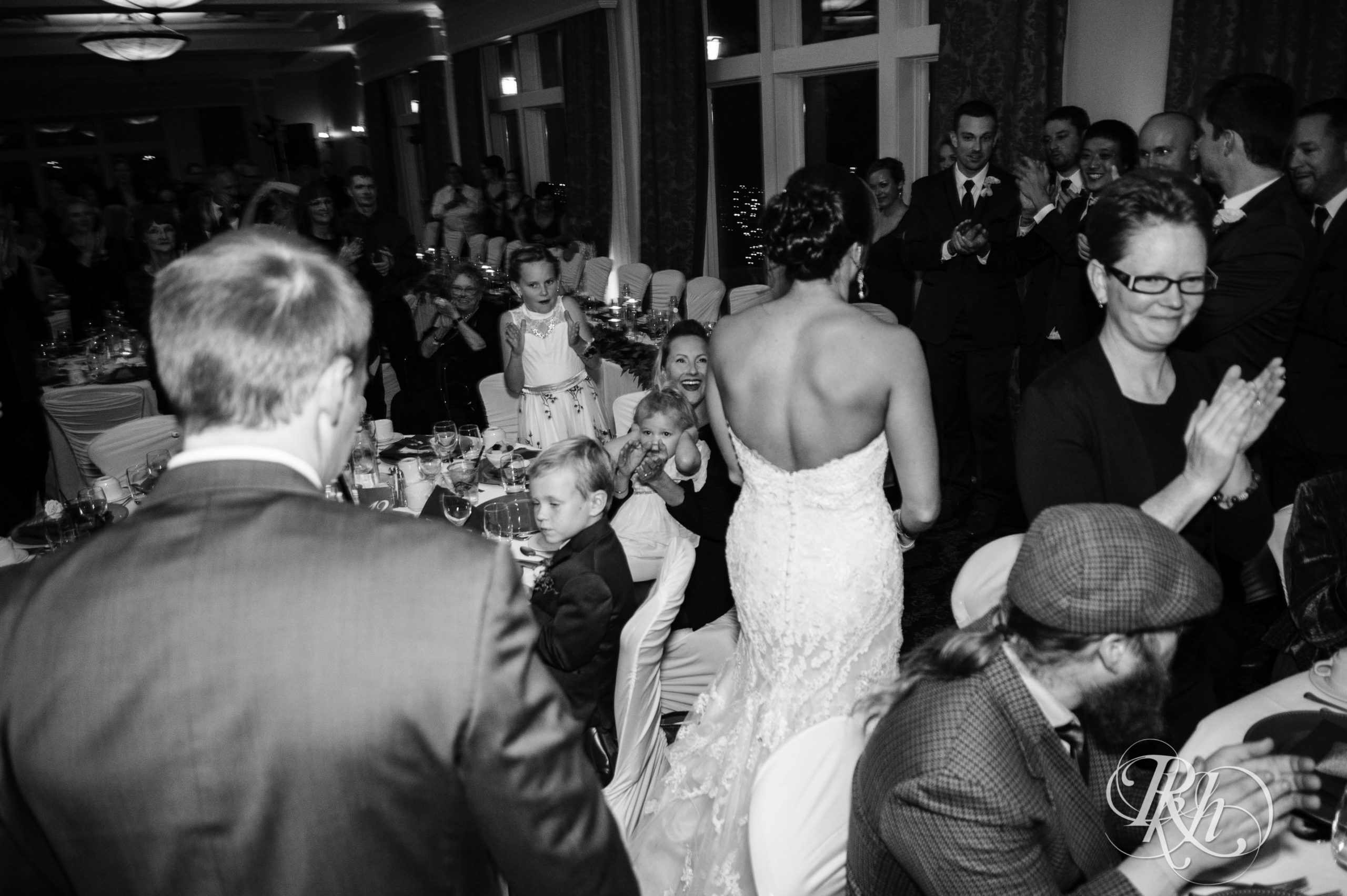 Bride and groom enter reception on fall wedding day at Minneapolis Golf Club in Minneapolis, Minnesota.