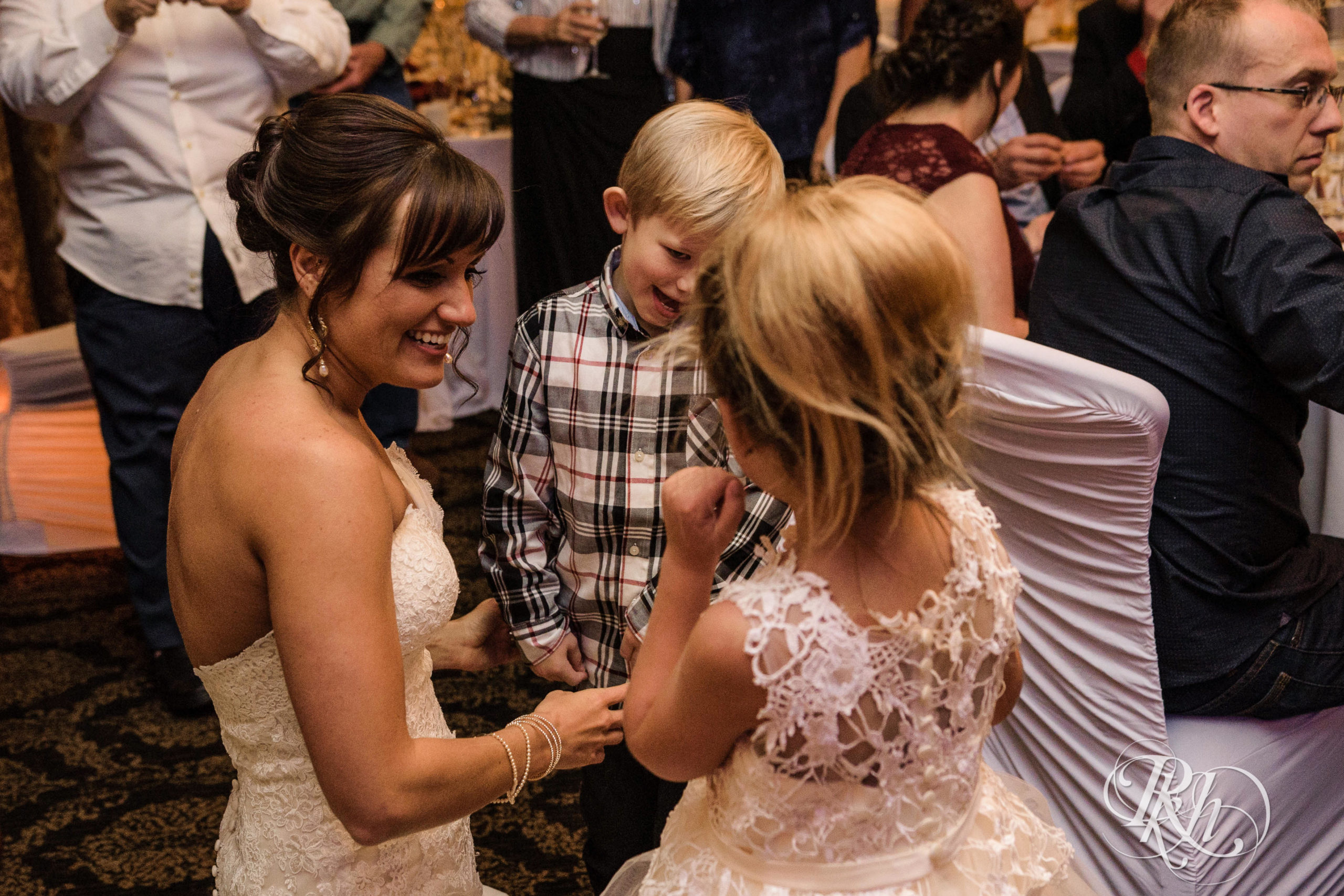 Bride dances with guests on fall wedding day at Minneapolis Golf Club in Minneapolis, Minnesota.
