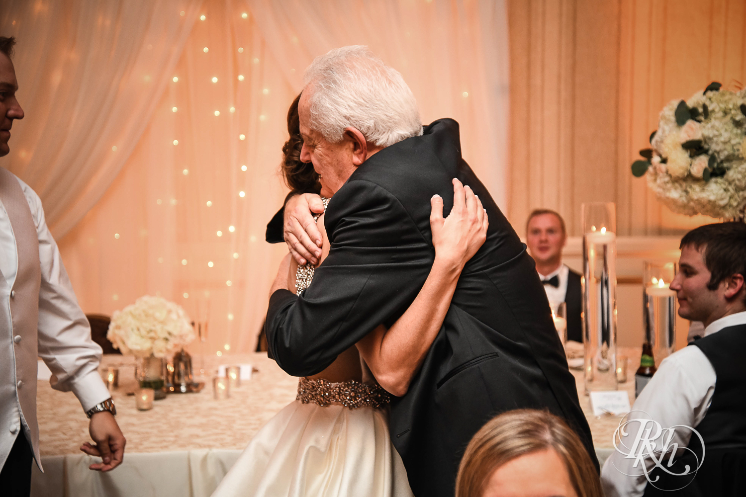 Bride hugs and cries during speeches at The Saint Paul Hotel in Saint Paul, Minnesota.