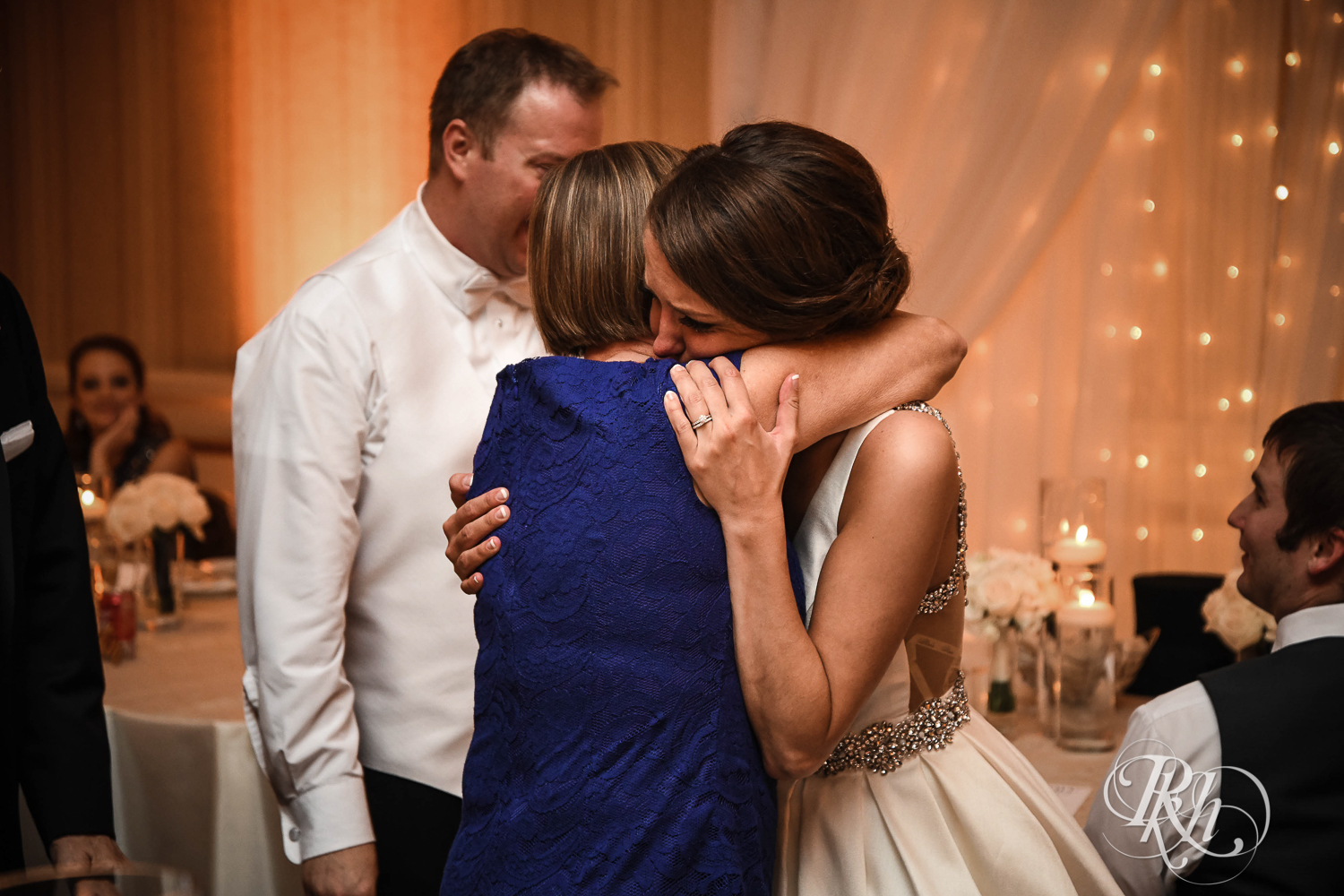 Bride hugs and cries during speeches at The Saint Paul Hotel in Saint Paul, Minnesota.