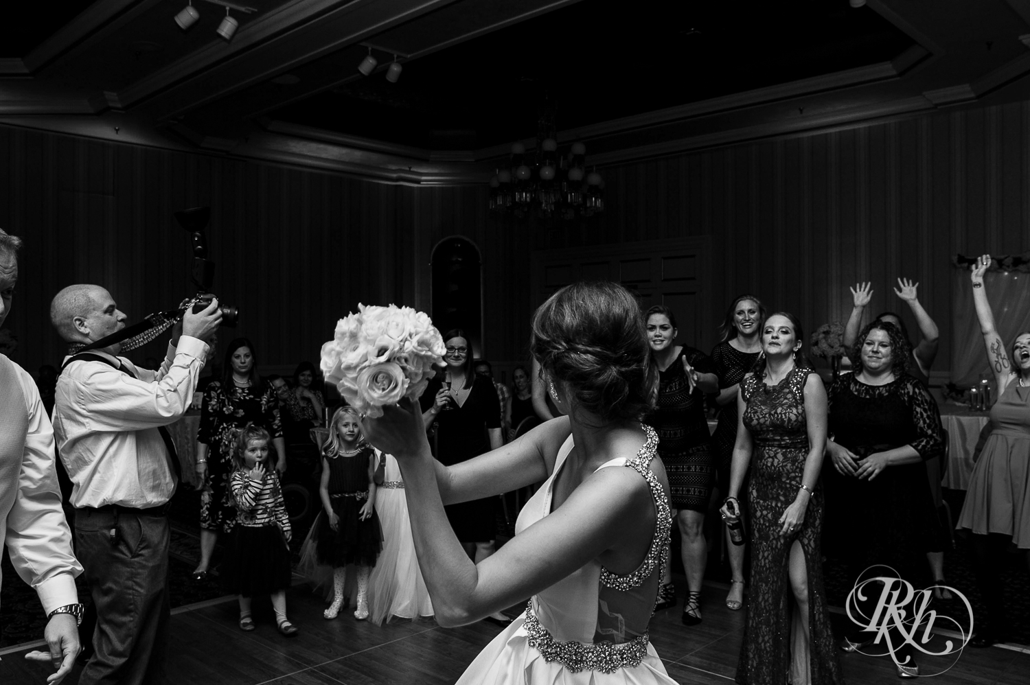 Bride throws bouquet at wedding reception at The Saint Paul Hotel in Saint Paul, Minnesota.