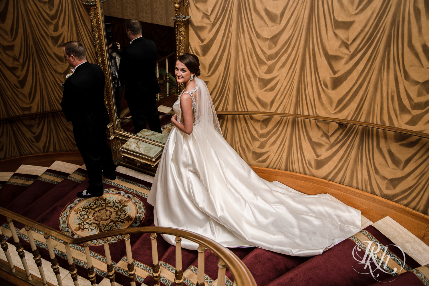 Bride and groom do first look on staircase at The Saint Paul Hotel in Saint Paul, Minnesota.