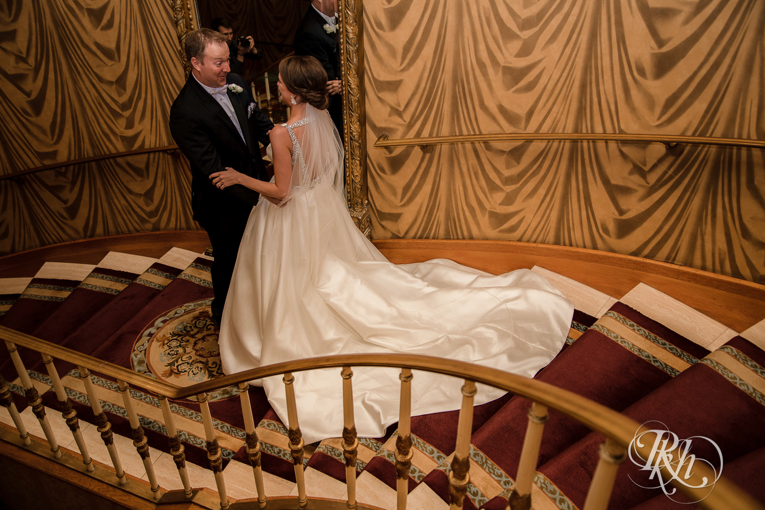 Bride and groom do first look on staircase at The Saint Paul Hotel in Saint Paul, Minnesota.