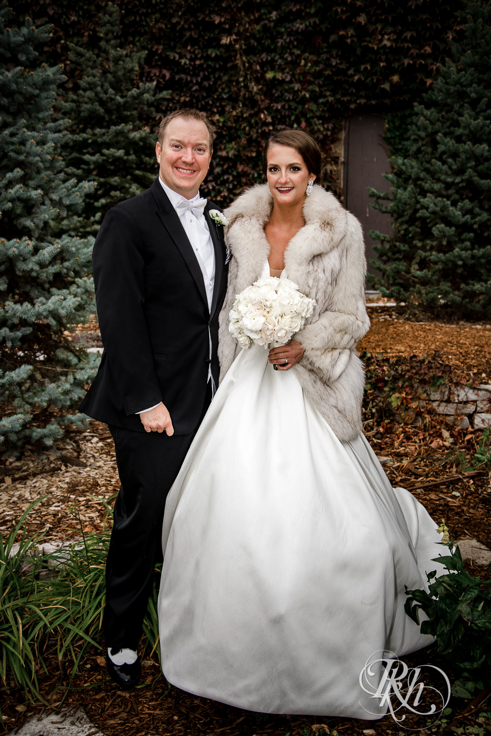 Bride and groom smile at The Saint Paul Hotel in Saint Paul, Minnesota.